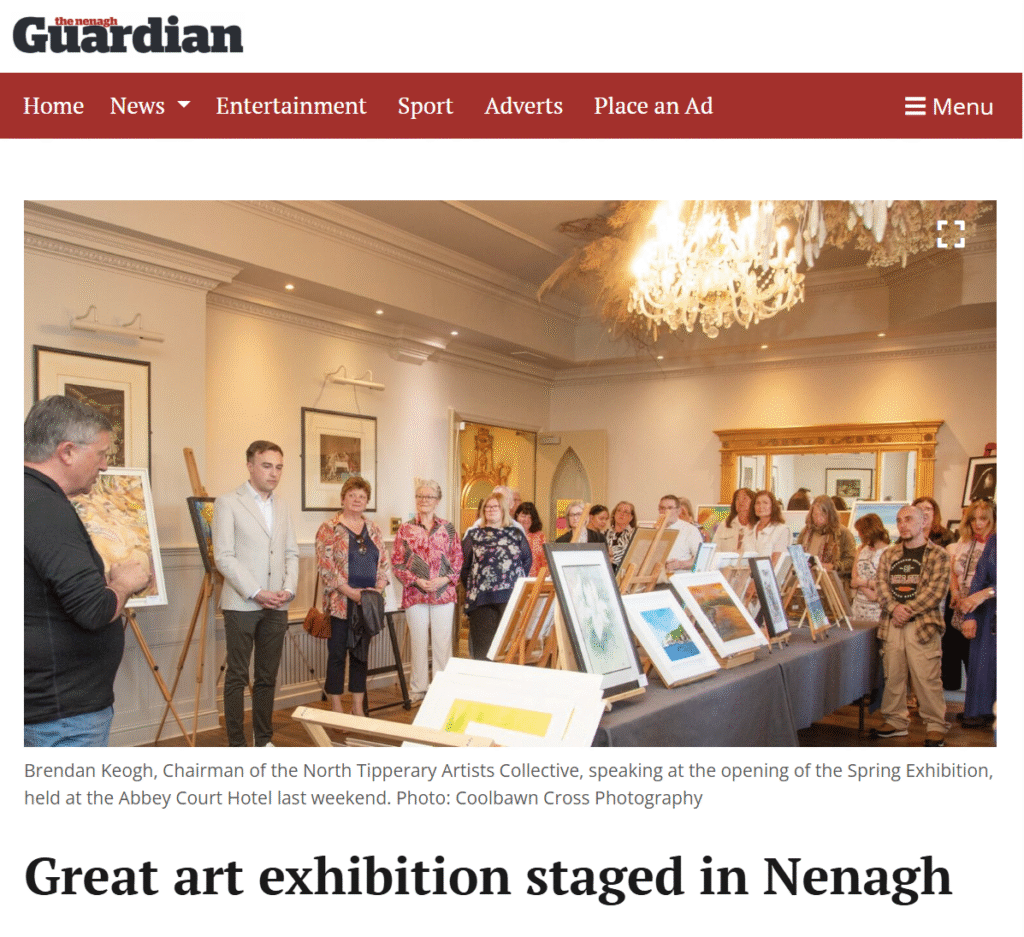 A large group of people attending an art exhibition in a well-lit room with framed artworks displayed on easels. The scene includes a speaker and guests engaging with the art.